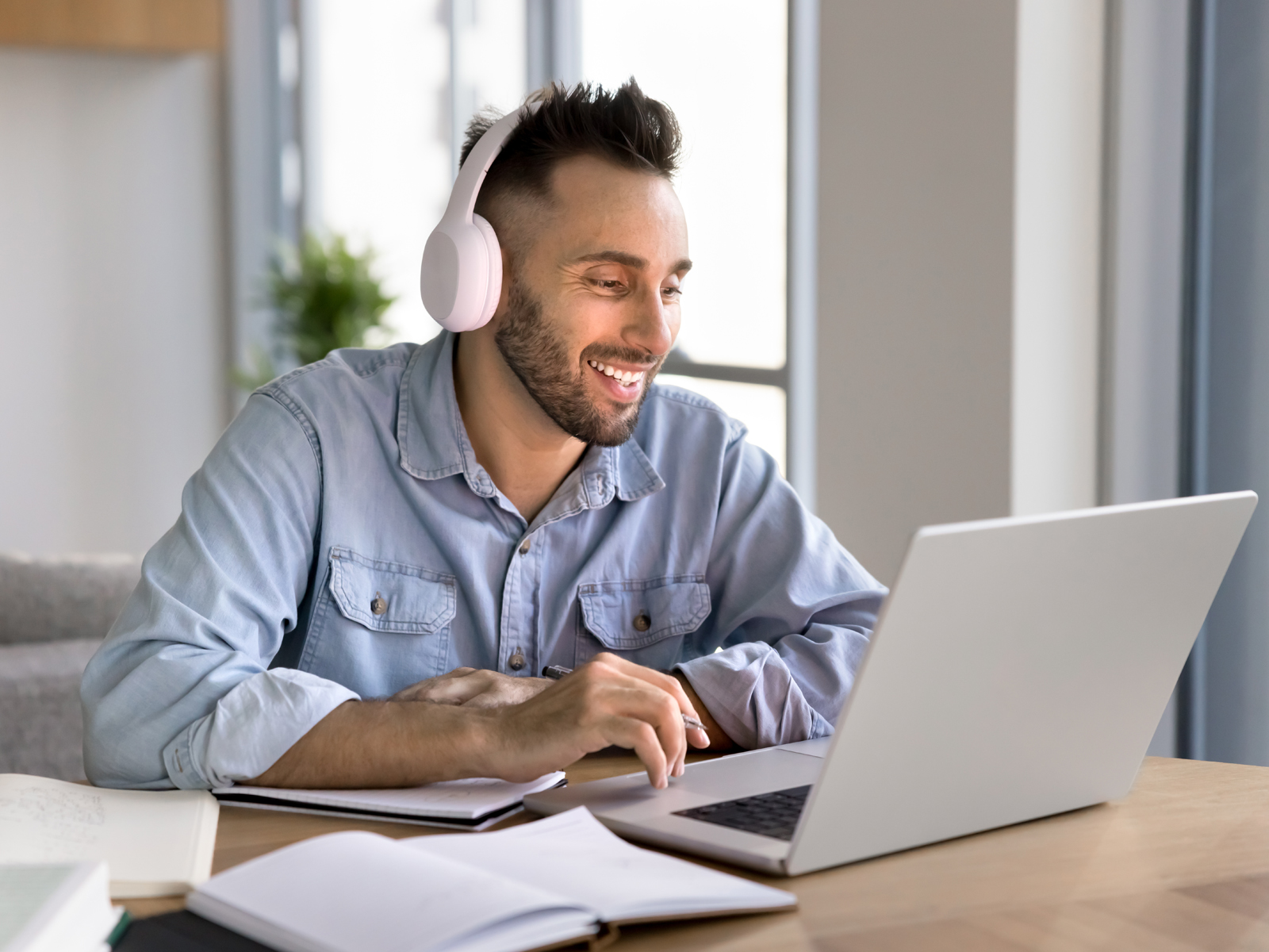 man using laptop with headphones