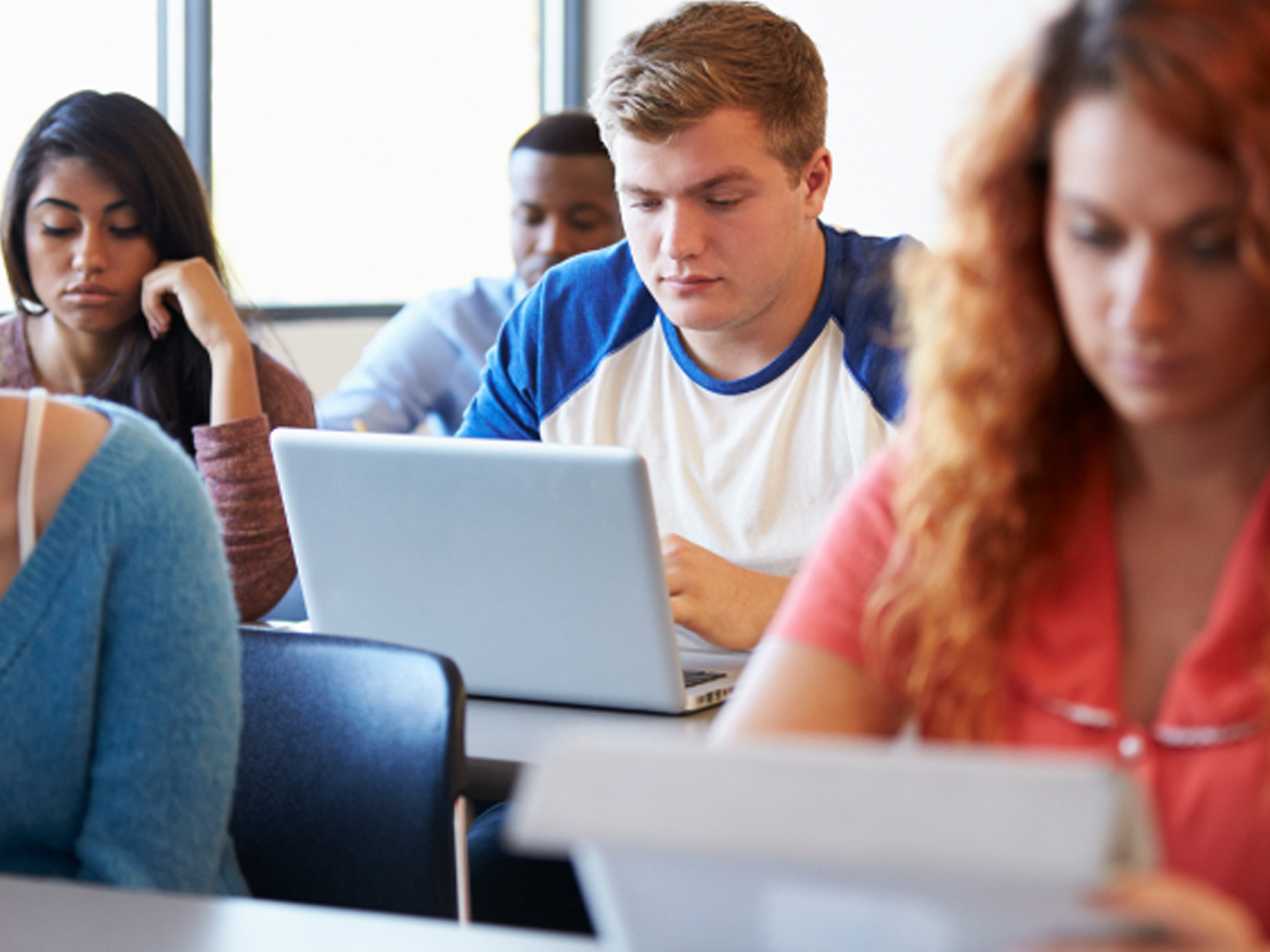college students in classroom with laptops