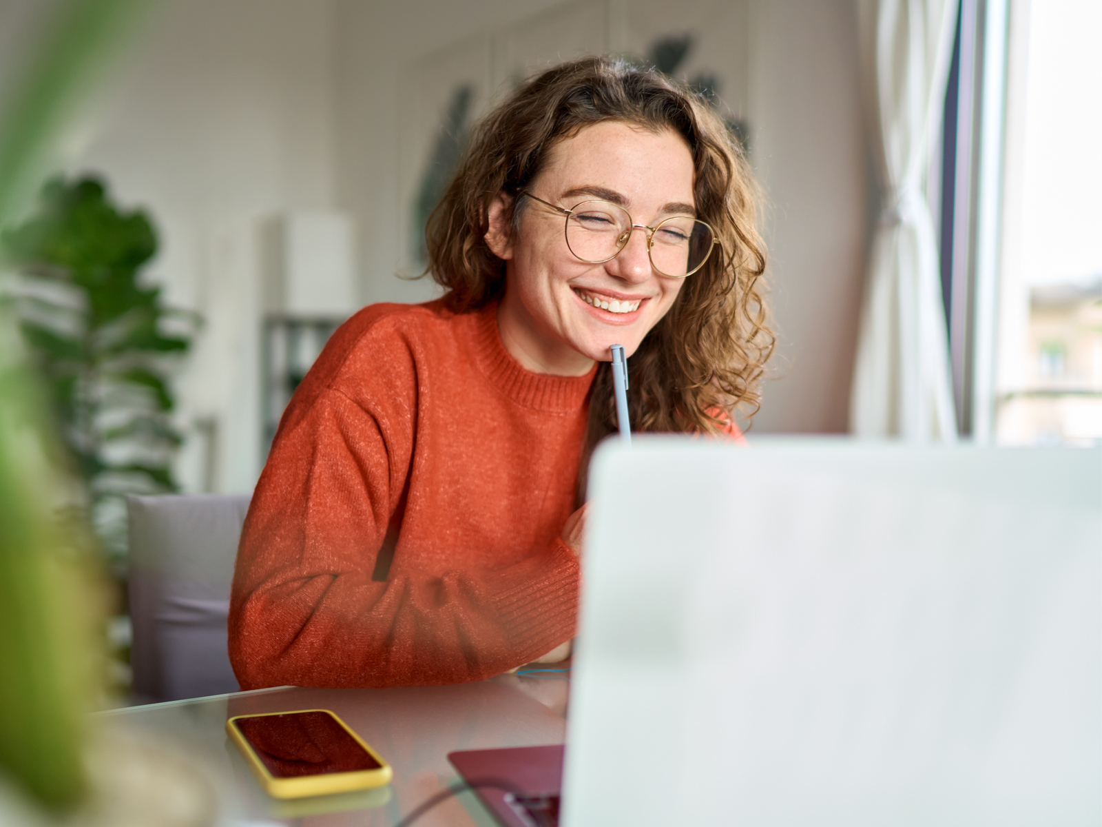 woman smiling at a laptop